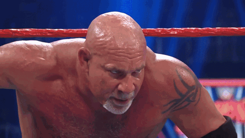 Bald Wrestler With Arm Tattoo in Ring