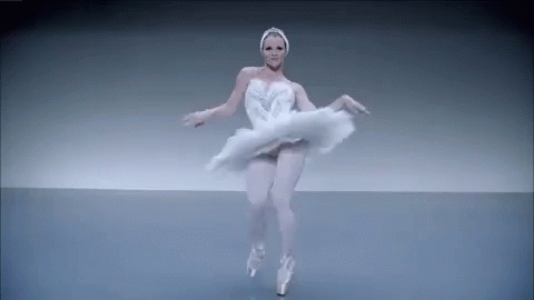 Ballerina in White Swan Dress Dancing on Stage