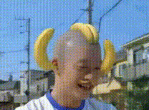 Banana Costume Mascot in Front of Fruchaland Sign