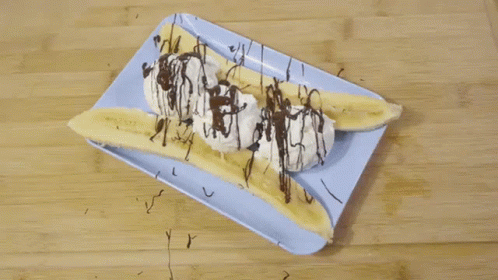 Banana Split With Whipped Cream and Chocolate Drizzle on Blue Plate