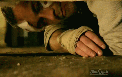 Bandaged Man Lying on Ground Saying Black Luck
