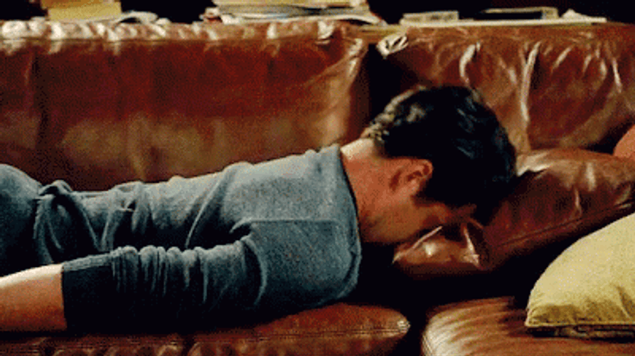 Banging Head Against Wall Guy Lounging  GIF