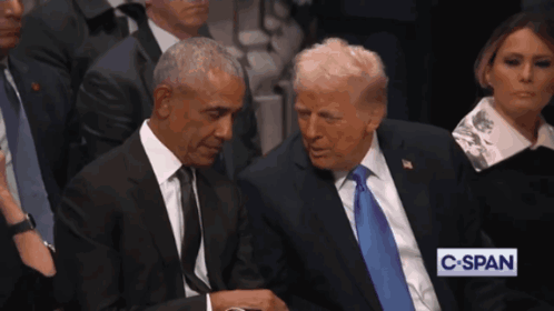 Barack Obama And Donald Trump Sit Next To Each Other In A Crowd GIF