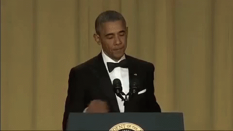 Barack Obama At Podium With Hand On Mouth GIF