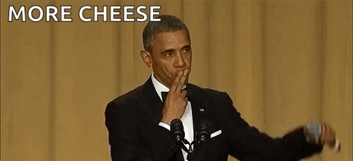 Barack Obama Is Giving A Speech In Front Of A Microphone While Covering His Mouth With His Hand . GIF