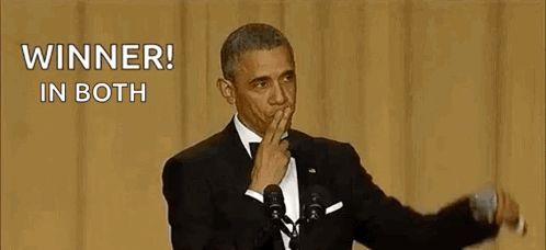 Barack Obama Is Holding His Hand To His Mouth While Giving A Speech At An Event . GIF
