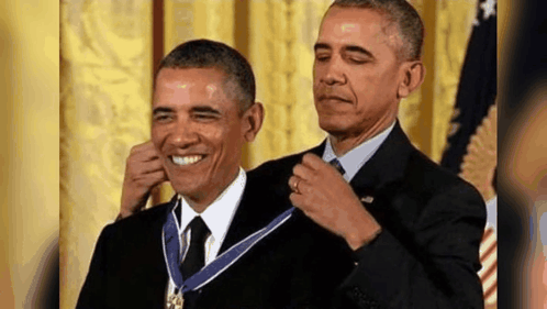 Barack Obama Is Receiving A Medal From Another Man . GIF