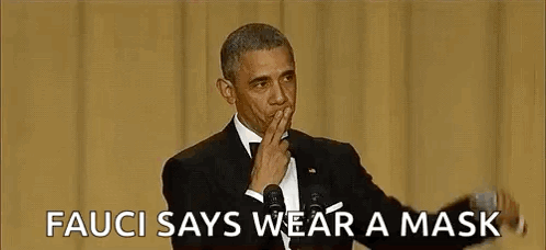 Barack Obama Is Wearing A Mask While Giving A Speech At An Event . GIF