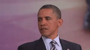 Barack Obama Is Wearing A Suit And Tie And Is Making A Funny Face . GIF