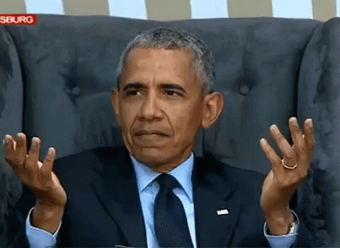 Barack Obama Sitting In A Chair With His Hands Up GIF