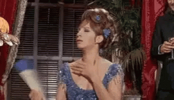 Barbra Streisand In Blue Dress Holding Fan GIF