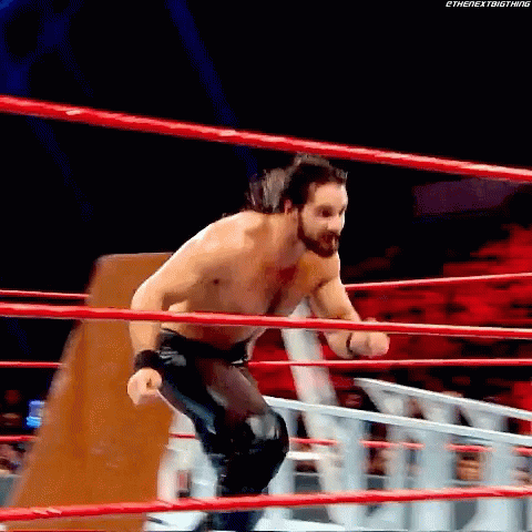 Baron Corbin Chokeslam Seth Rollins On Table GIF