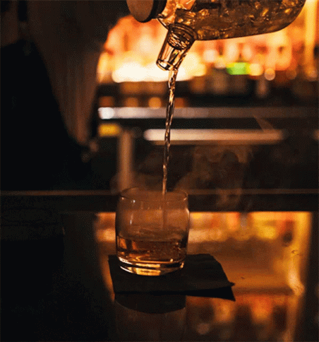 Bartender Pours Glass of Whiskey