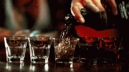 Bartender Pours Liquor Into Shot Glasses GIF