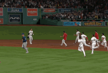 Baseball Game in Front of Aura Banner