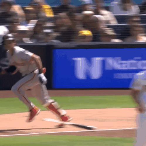 Baseball Game in Front of Blue Sign