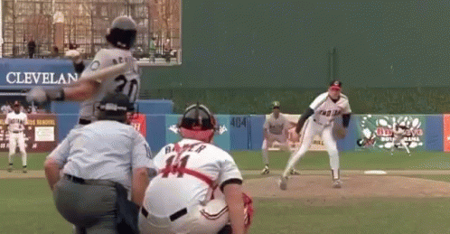 Baseball Game in Front of Cleveland Banner
