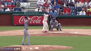 Baseball Game In Front Of Coca Cola Banner GIF