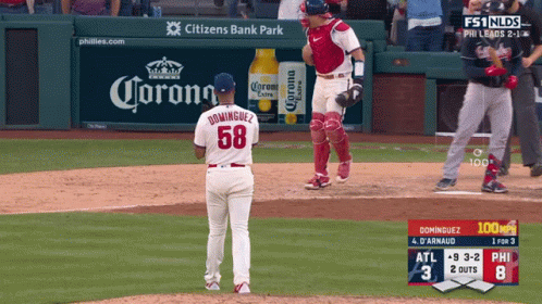 Baseball Game In Front Of Corona Ad GIF