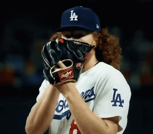 Baseball Player Covering Face With LA Hat And Glove GIF