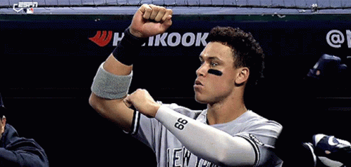Baseball Player Flexing in Front of Kook Banner
