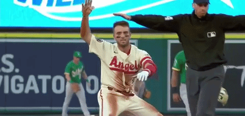 Baseball Player in Angels Uniform Being Chased