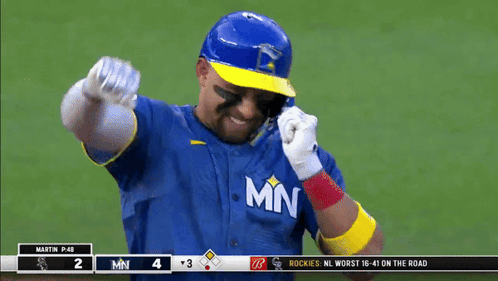 Baseball Player in Blue and Yellow Jersey With MN