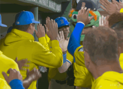 Baseball Player in Blue Hat With B Giving High Five