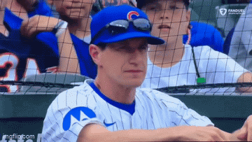 Baseball Player In Blue Hat With Letter C Sitting In Dugout GIF
