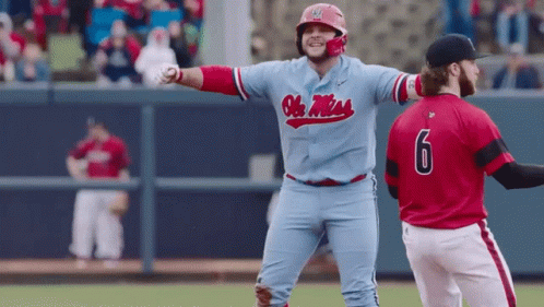 Baseball Player in Blue Ole Miss Jersey Next to Player in Red Jersey Number 6