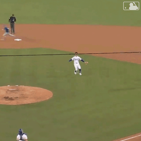 Baseball Player in Dodgers Jersey Catching Ball