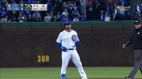 Baseball Player in Front of Cubs Scoreboard
