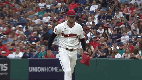 Baseball Player in Guardians Jersey in Front of Union Home Sign