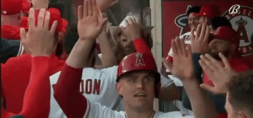 Baseball Player In Helmet With A High Five GIF