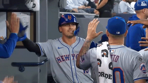 Baseball Player in Mets Uniform High Fiving Teammates
