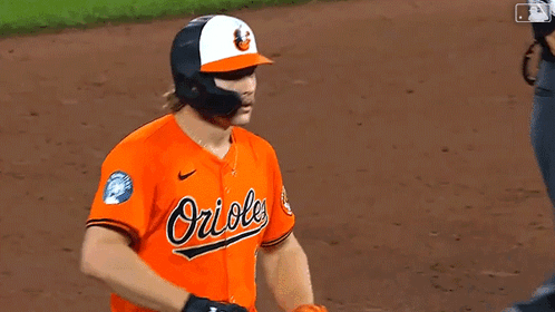 Baseball Player in Orioles Jersey and Helmet