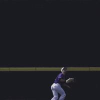 Baseball Player in Purple Uniform Sliding Into Base