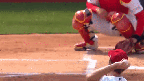 Baseball Player in Red Hat Kneeling