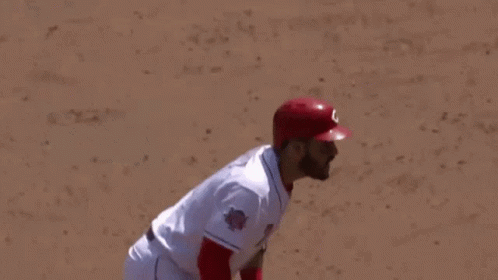Baseball Player in Red Helmet Gloves Swinging Bat