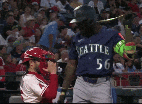 Baseball Player in Seattle Uniform Standing in Front of Catcher