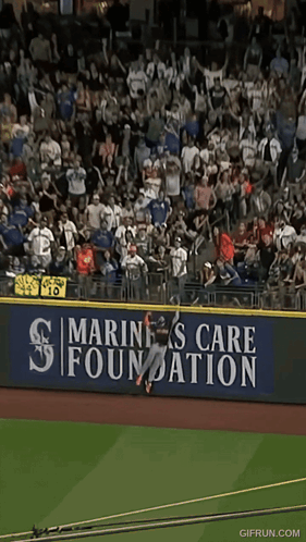 Baseball Player Jumping Over Fence GIF