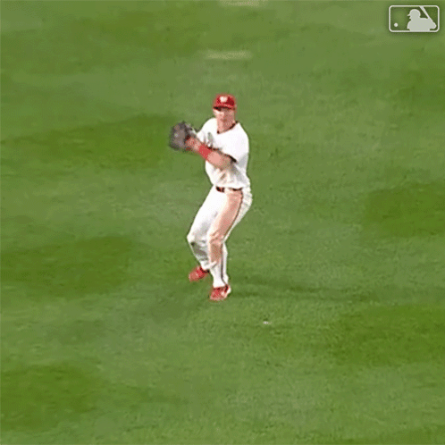 Baseball Player Jumping to Catch Ball