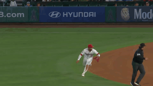 Baseball Player Laying on Ground With Scoreboard Saying Mid Eighth