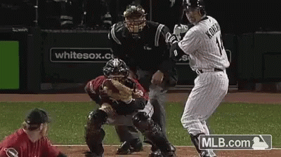 Baseball Player Number 11 Swinging at Pitch