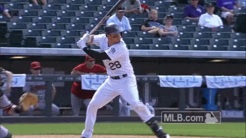 Baseball Player Number 12 Swinging Bat