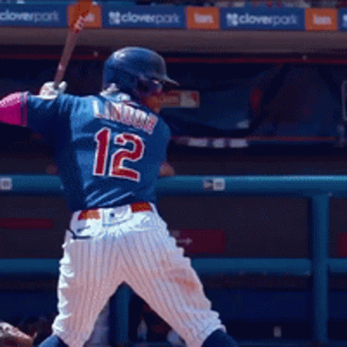 Baseball Player Number 12 Swings Bat