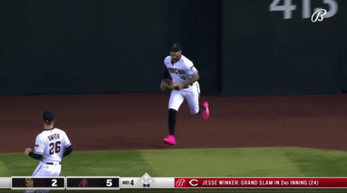 Baseball Player Number 26 Running to Another Player
