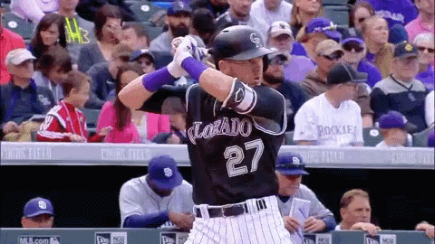Baseball Player Number 27 Swinging at Pitch