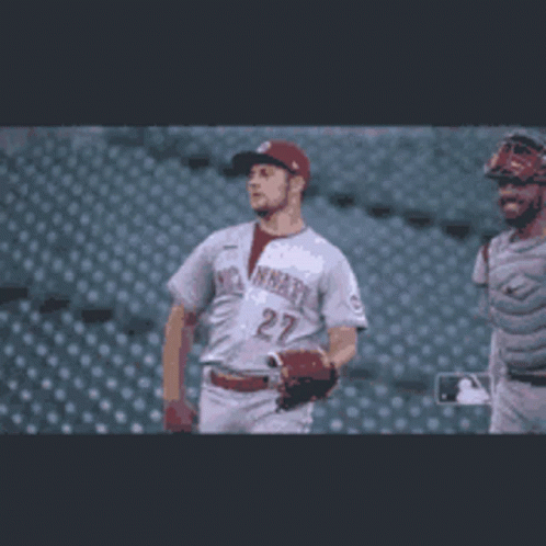 Baseball Player Number 27 Walking With Catcher