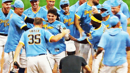 Baseball Player Number 35 Surrounded by Players